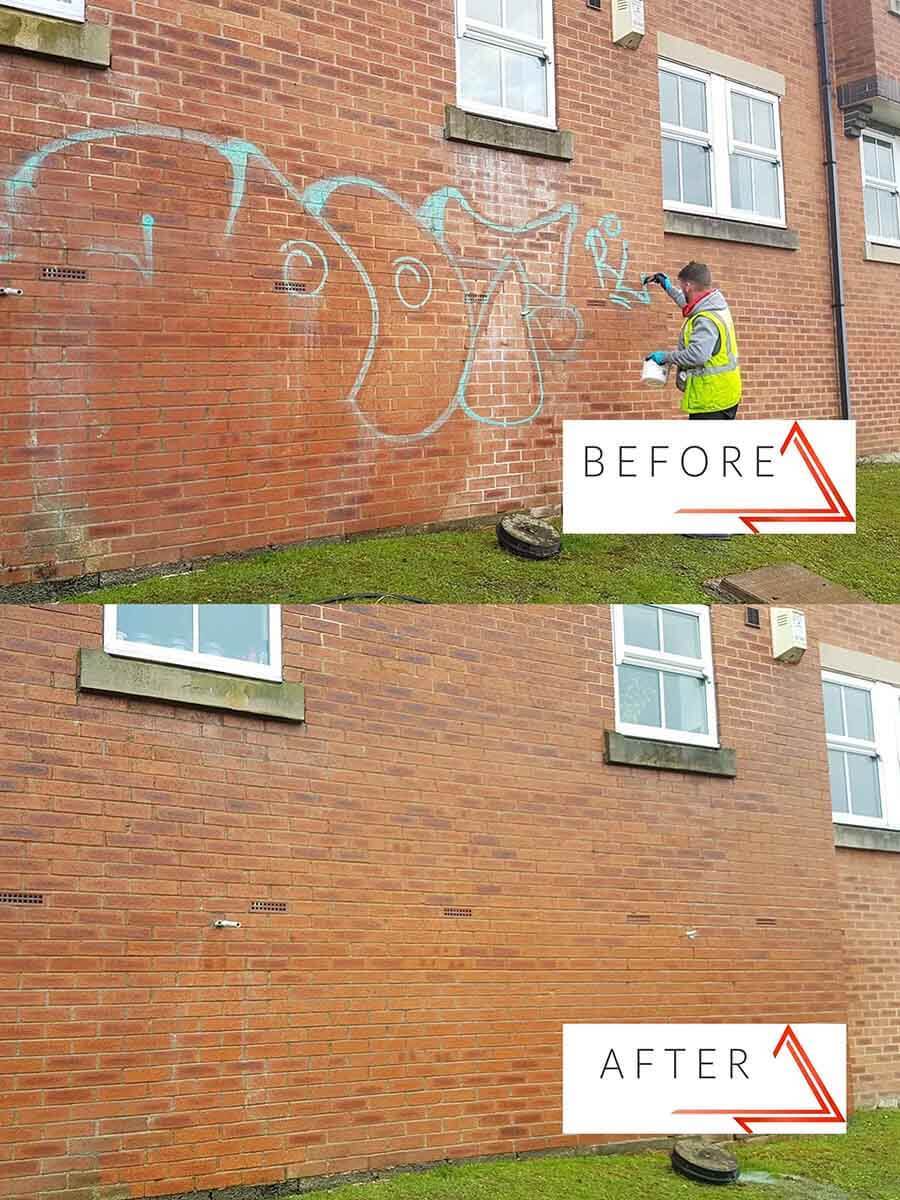 Graffiti removal from brick wall on building