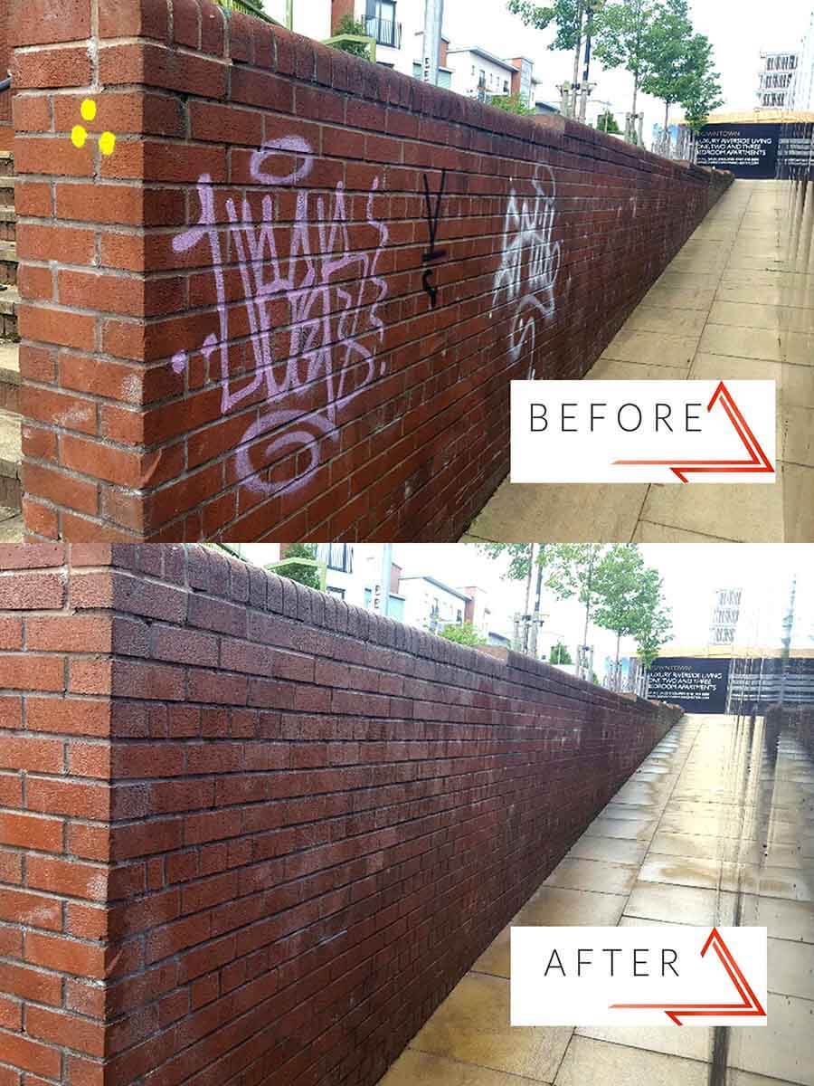 Graffiti removal from brick wall on walkway
